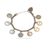 A silver chain bracelet with eight, Dutch, silver coin charms