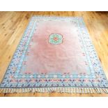 A Moroccan carpet, the green medallion on a pink field