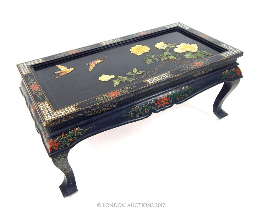 A 20th century Chinese black lacquered, painted and gilded low table, the top inlaid with mother of