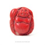 A Chinese hand-carved red coral Buddha pendant