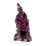 An early 20th century, hand-carved, boxwood figurine of a seated Japanese gentleman