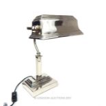 A contemporary chromed bankers desk lamp with adjustable shade