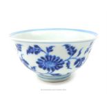 A Chinese blue and white porcelain bowl, hand painted with flowers to the interior and exterior