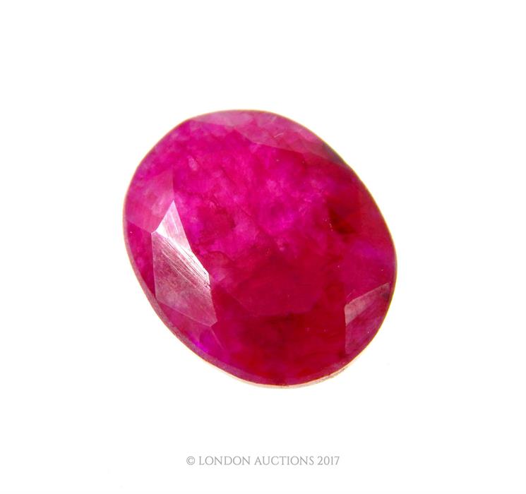 A 10.2 carat natural, oval shaped, faceted pink ruby with eye-visible inclusions (loose stone) - Image 2 of 3