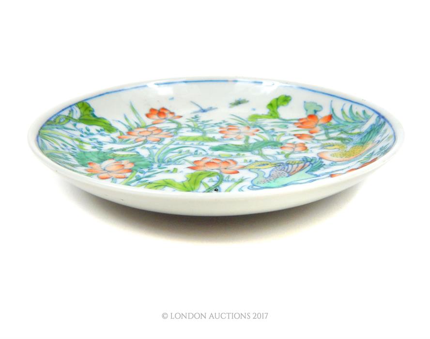 A Chinese porcelain dish, hand painted in the doucai palette with ducks swimming between lilies - Image 2 of 3