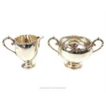 A matching hallmarked sterling silver milk jug and sugar bowl, assayed in London in 1922