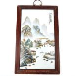 A Chinese framed porcelain plaque, hand painted with a mountainous landscape