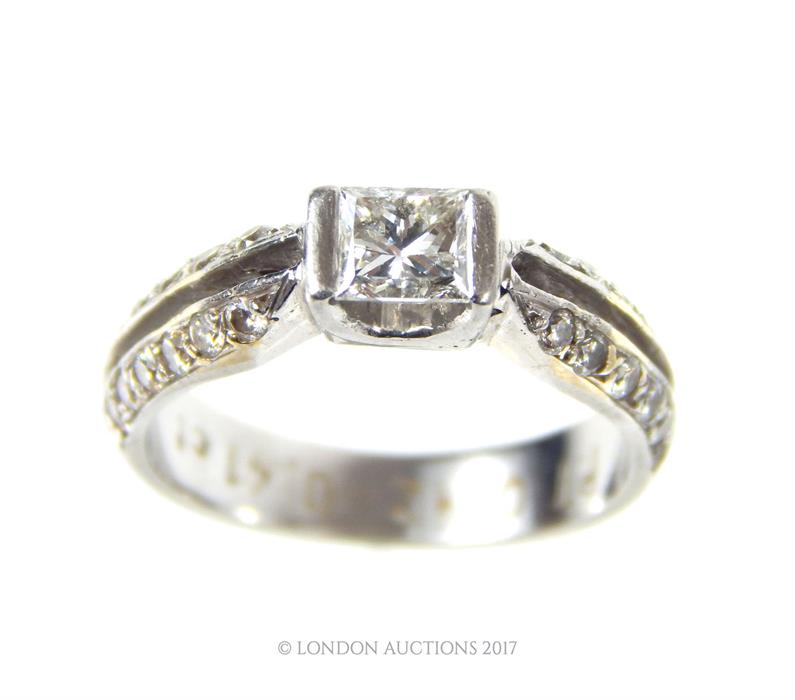 A boxed, platinum, diamond solitaire ring