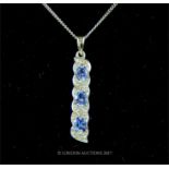 An elegant, 9 ct white gold, tanzanite and diamond pendant and chain