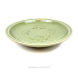 A Chinese Longquan celadon style bowl, the inside decorated with four fish in relief