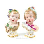 A pair of 19th century Meissen child busts with one child wearing a garland (25cm high) and the