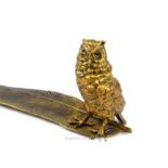 A gilt bronzed metal owl on quill style inkwell stand; 34cm long.