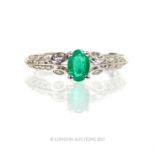 An 18 ct white gold, emerald and diamond ring