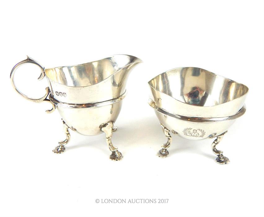 A matching Victorian hallmarked sterling silver milk jug and sugar bowl, assayed in London in 1892