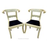 A pair of Indian Regency style chairs, clad in white metal with chased decoration