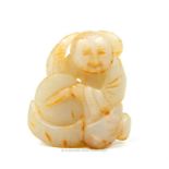 A Chinese white jade carving in the form of a seated figure