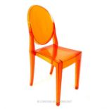 A Kartell Victoria Ghost Chair in orange