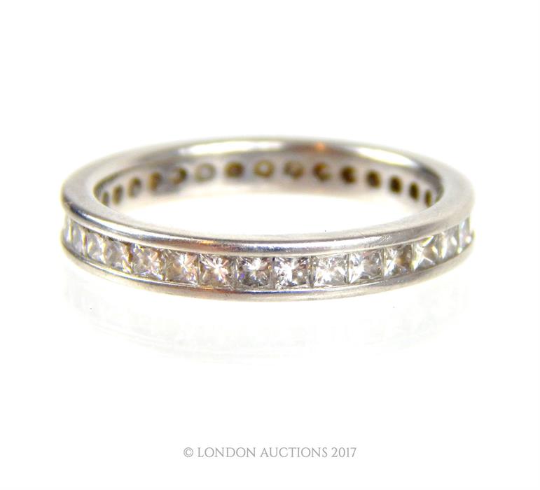 A boxed, platinum and diamond set eternity band