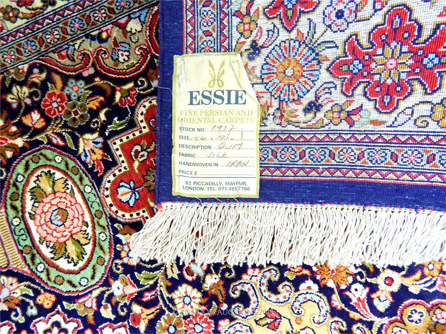 A signed Persian silk Qum rug, with a central medallion on a midnight blue field, profusely - Image 2 of 2