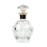 A crystal decanter with a sterling silver decanter, Goldsmiths & Silversmiths Co Ltd