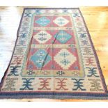 An old Turkish Anatolian Kelim rug, decorated with six ivory medallions on three red sections