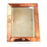 An Arts and Crafts rectangular wall mirror, having a copper frame