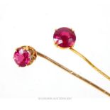 Two 18ct gold and ruby stick pins, each having a single round cut ruby