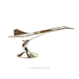 An Art Deco style chromed sculpture of a Concorde in flight