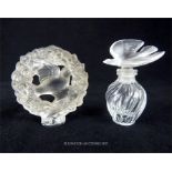 Two Lalique cast glass items to include a large, circular, perfume bottle stopper and perfume bottle