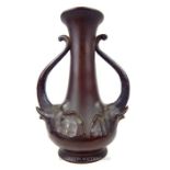 An unusual early 20th century bronze vase, having twin twisted handles with elephant head designs