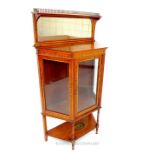 A late Victorian satinwood display cabinet with mirror top; decorated with a profusion of hand