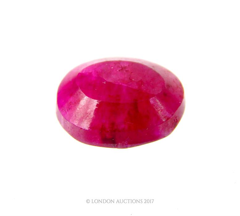 A 10.2 carat natural, oval shaped, faceted pink ruby with eye-visible inclusions (loose stone) - Image 3 of 3