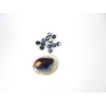 A slice of agate set in a white metal brooch, together with a collection of banded amber beads