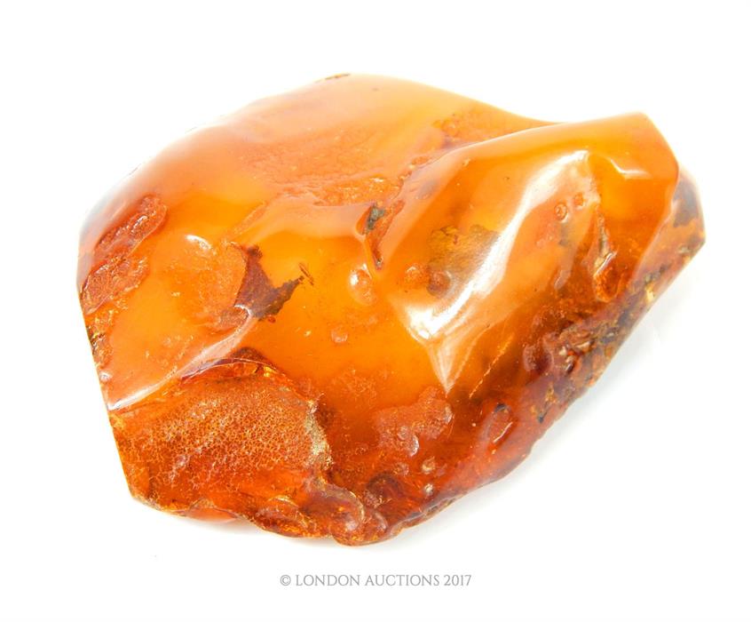 A large chunk of natural Baltic amber, containing some flakes of gold, 130g.