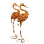 A pair of life size painted and distressed metal figures of cranes