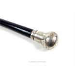 An Edwardian, ebonised walking cane with a sterling silver top