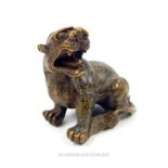 A Chinese bronzed metal lion; 9.5cm long.