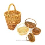 A collection of five various wicker baskets.