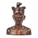 An African carved wood bust of a male youth; 26cm high.