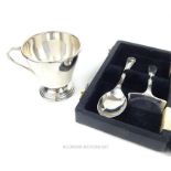 A cased sterling silver child's spoon and pusher with a sterling silver Christening mug