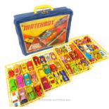 A retro Matchbox carry case, filled with various die-cast model Matchbox model vehicles, including