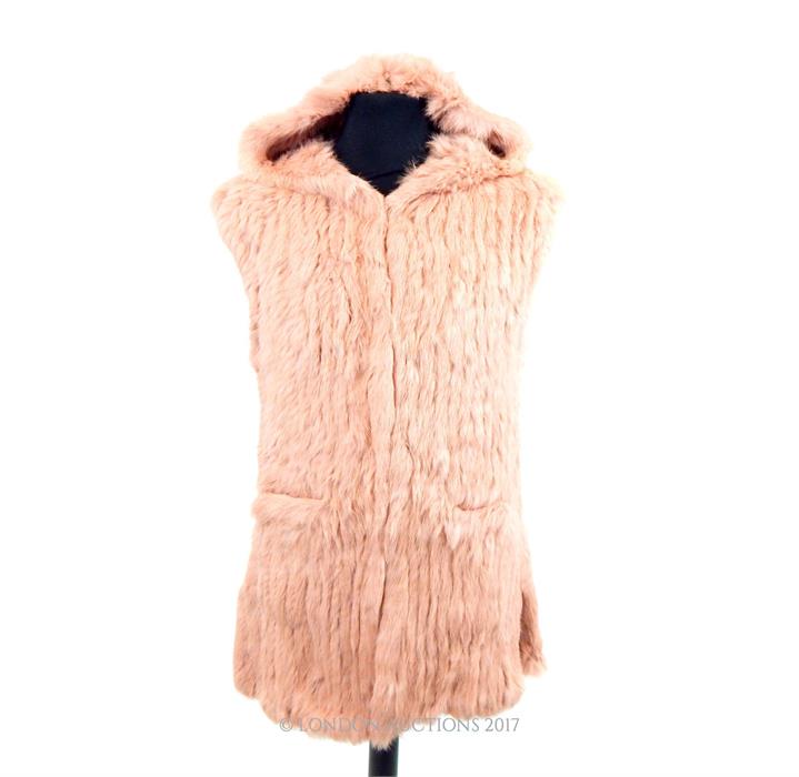 A brand-new, ladies, pale pink, rabbit fur gillet with hood