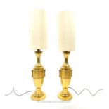 A pair of Chinese brass table lamps, having ivory coloured cylindrical shades