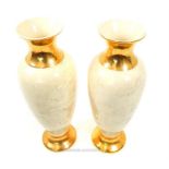 A pair or large ceramic vases, parcel gilt with a faux marble finish