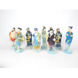 Eight Oriental figurines, hand painted in vibrant colours; all approximately 18cm tall. (8)