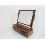 A Regency mahogany bow-front dressing table mirror; 55cm wide.