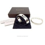 A boxed, authentic, Gucci sterling silver cuff bangle with other sterling silver bracelet