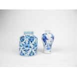 A Delft ware lidded jar (11.5cm high) together with a small blue and vase (12cm high). (2)