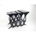 A nest of four Regency ebonised tables; largest 49.5cm wide 68cm high.