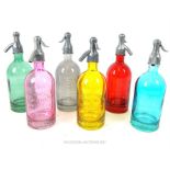 A set of six coloured glass models of soda siphons